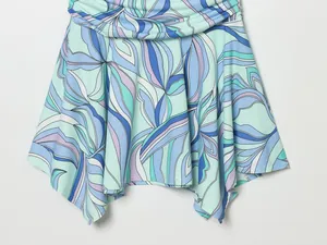 Gros plan sur l'imprimé floral abstrait bleu et menthe d'une robe d'été évasée