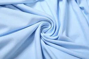 High-resolution macro detail of light blue ribbed fabric texture showing fine weave