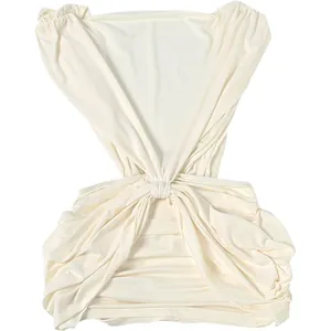 Detailed macro view showing the textured ruched fabric of this cream deep V-neck dress