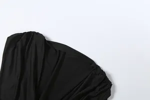 Close-up detail of the pleated shoulder on a sexy deep V-neck black sleeveless dress.