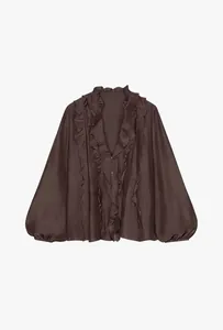 Detail showing the ruffle layers and button closure on this chocolate brown blouse.