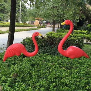 Decorative pair of vibrant pink plastic flamingo statues for garden and landscape decor