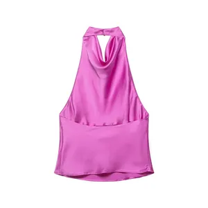 Macro view of pink silk satin halter top featuring a elegant cowl neck backless design.