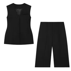Detailed view of women's black vest and wide-leg shorts set with hidden buttons.