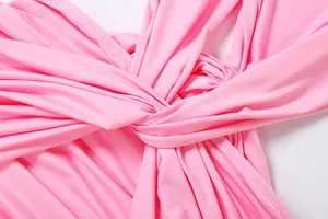 Detail view showing the elegant twist and pleated fabric on a pink sleeveless dress