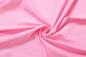 Detail view of high-quality soft pink elastic fabric with fine ribbed knit texture.