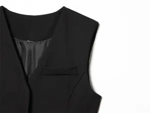 Detailed close-up of women's black suit vest featuring a stylish flap pocket detail