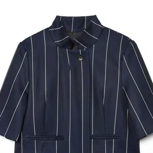 Close-up of navy blue striped short jacket featuring a stand collar and button