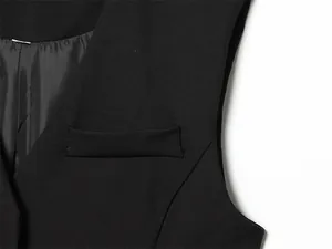 Detailed close-up shot of a black suit vest showing the flap pocket and fabric.