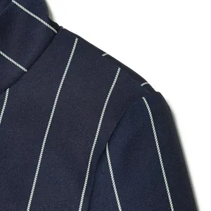 Macro detail showing navy blue pinstripe blazer shoulder seam and premium fabric texture