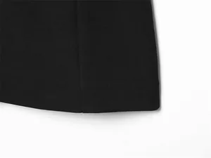 Macro detail of black fabric hem showing clean stitching and smooth texture