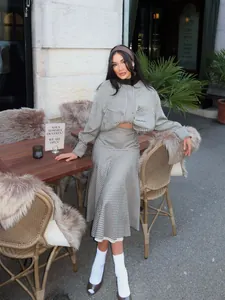 Retro houndstooth bomber jacket and flared skirt set in an outdoor cafe setting