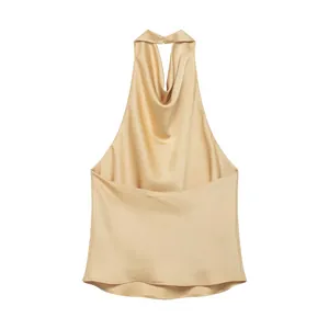 Close-up of elegant champagne gold satin halter neck top showing smooth fabric and cowl drape