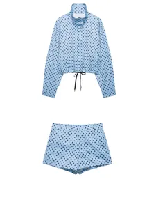 Flat lay detail of a blue polka dot seersucker cropped jacket and matching shorts set