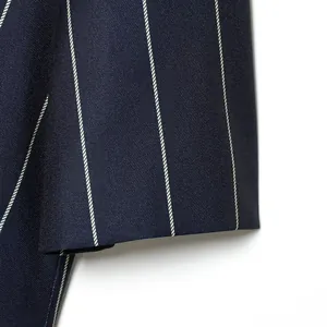 Close-up of navy blue pinstripe fabric showing twill texture and sleeve finishing