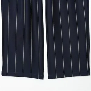 Close-up of navy blue pinstriped straight-leg trouser hem showing fabric texture.