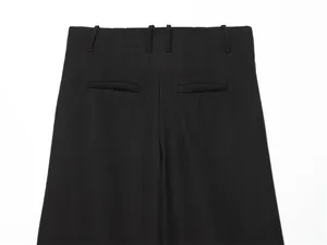 Detailed back view of black high-waisted dress shorts featuring belt loops and pockets