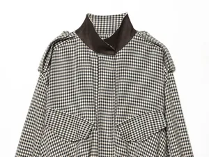 Detail of a retro houndstooth pilot jacket with contrast high collar and epaulets