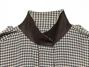 Detailed macro view of retro plaid pilot jacket collar with brown contrast suede texture