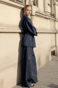 Detailed view of a stylish two-piece denim set featuring a lapel jacket and wide-leg pants