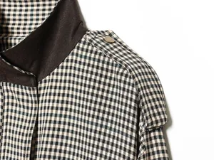Close-up of retro houndstooth bomber jacket with suede collar and shoulder epaulette