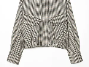 Close-up of a vintage gingham cropped bomber jacket with flap pockets and elastic waist.