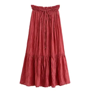 Close-up detail view of a dark rose red tiered maxi skirt with crinkled fabric texture.