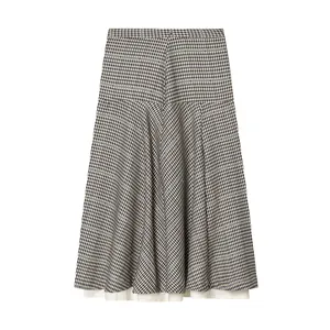 Detailed view of a vintage plaid skirt featuring a layered hem and pleated texture