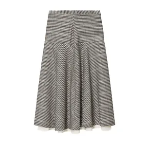 Macro view of a retro plaid A-line midi skirt with an elegant white hem lining