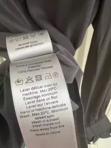Detailed view of the garment care label showing 100% viscose material on a gray shirt