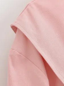 Close-up view of premium pink twill fabric and neat stitching on a fashion jacket