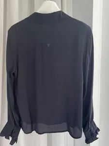 Elegant dark navy satin silk blouse with ruffled cuffs and subtle crinkle texture