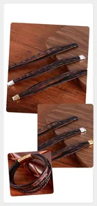 Gros plan de bracelets en cuir tressé vintage avec motif de croix et fermoirs en alliage