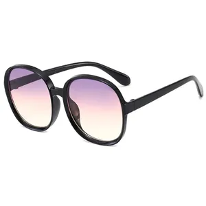 Vintage oversized round sunglasses for women with purple to yellow gradient lenses