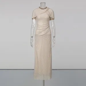 Elegant champagne floor-length dress with cape sleeves and crystal neckline detail.