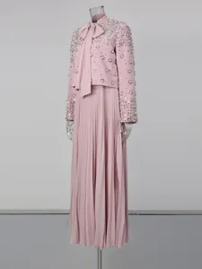 Elegant light pink two-piece set featuring a heavy beaded jacket with bow and pleated skirt