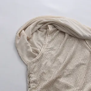 Detailed macro shot of champagne mesh hooded dress with shimmering silver rhinestone embellishments