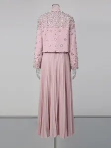 Detailed back view of an elegant pink skirt set with heavy beadwork and pleats