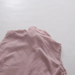 Close-up detail of mauve retro elegant skirt set showing side zipper and fabric texture.