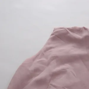 Macro view showing the soft texture of a dusty rose elegant vintage beaded dress