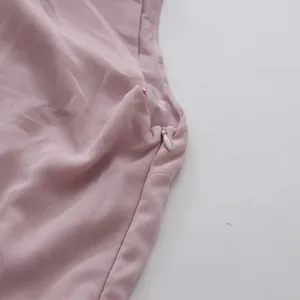 Close-up of elegant mauve dress showing high-quality hidden side zipper detail