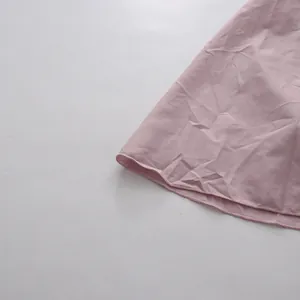 Detailed macro view showing the hemline stitching on a dusty rose elegant vintage skirt
