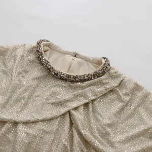 Close-up detail of the round neckline and sparkling rhinestone embellishments on this dress