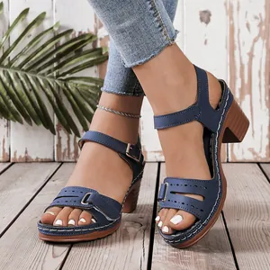 Close-up of blue peep-toe wedge sandals with cutout details and chunky block heels