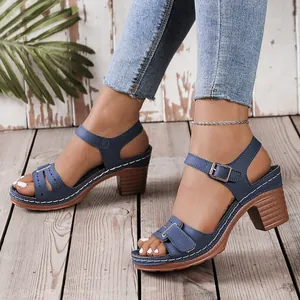 Detail view of blue chunky heel sandals with contrast stitching and strap closure