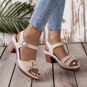 Detailed view of women's beige peep-toe sandals featuring block heels and Velcro straps.