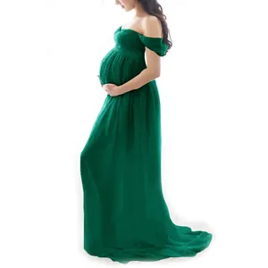 Side view of a deep green off-the-shoulder maternity gown for photography sessions.