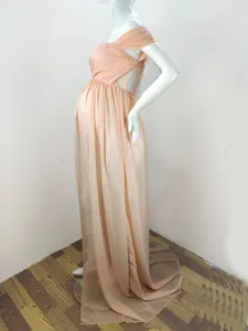Detail of peach lace bodice and flowing chiffon trail on maternity photography gown