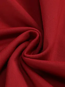 Close-up macro view of wine red ribbed fabric texture for elegant banquet dresses