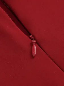 Close-up detail showing the high-quality invisible zipper on a red elegant dress